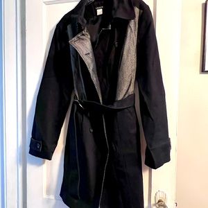 Black trench coat with chevron print.